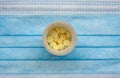 Tablets in container on blue mask background Royalty Free Stock Photo