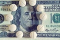 Tablets on dollar bills (treatment, addiction, aging - concept). Vintage effect. Royalty Free Stock Photo