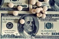 Tablets on dollar bills (treatment, addiction, aging - concept). Vintage effect. Royalty Free Stock Photo