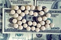 Tablets on dollar bills (treatment, addiction, aging - concept). Vintage effect. Royalty Free Stock Photo