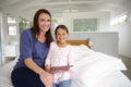 Tablets are great for curious little minds. a little girl using a tablet with the help of her mother. Royalty Free Stock Photo