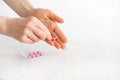 Tablets in hand on a white background close-up. Royalty Free Stock Photo