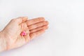 Tablets in hand on a white background close-up. Royalty Free Stock Photo