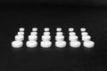 Tablets lined in rows on a black background, different size, close up