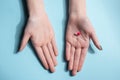 Tablets in the palm of your hand. Vitamin tablets and capsules on a blue background