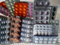 Tablets, pills, capsules for various diseases in blisters. Medications are neatly folded. Medical background