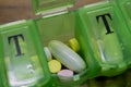 Tablets and pills organiser in a close-up picture Royalty Free Stock Photo