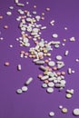 Tablets scattered on a violet background.