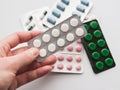 10 tablets in a silver blister in hand on a white background close-up. The concept of medication Royalty Free Stock Photo