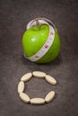 Tablets of Vitamin C and apple green. Royalty Free Stock Photo