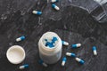 Tablets. Dropping pills and a glass of water from the hands.