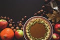 Tableware, homemade pumpkin pie, pumpkin and acorns on dark wooden background. Thanksgiving day holiday concept. Top view. Royalty Free Stock Photo