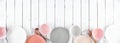Tableware set in pastel pink, coral, white and grey. Above view, border on a white wood banner background. Royalty Free Stock Photo