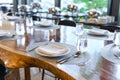 Tableware setting in the restaurant. Decorated elegant table, porcelain plates, glasses, napkin, knife, fork and spoon