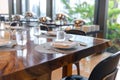 Tableware setting in the restaurant. Decorated elegant table, porcelain plates, glasses, napkin, knife, fork and spoon