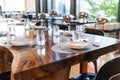 Tableware setting in the restaurant. Decorated elegant table, porcelain plates, glasses, napkin, knife, fork and spoon on table