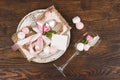 Tableware and silverware with puffy light pink roses on the wooden background Royalty Free Stock Photo