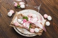 Tableware and silverware with puffy light pink roses Royalty Free Stock Photo