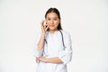 Taboo, medical confidentiality concept. Young asian doctor, female physician showing mouth silence, taboo or zip gesture Royalty Free Stock Photo