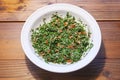 Taboule, Lebanese parsley salad with tomatoes, onions and mint in a white bowl on a rustic wooden table, seen from above, copy Royalty Free Stock Photo