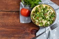 Tabbouleh salad in a round plate on a wooden background