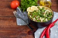 Tabbouleh salad in a round plate on a wooden background