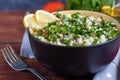 Tabbouleh salad in a round plate on a wooden background