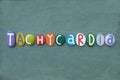 Tachycardia, medical term composed with multi colored stone letters over green sand