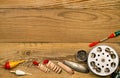 Tackle and fishing accessories against a wood background. Royalty Free Stock Photo