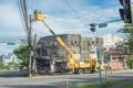 Tacloban, Leyte, Philippines - Two linemen on a manlift platform doing checkup and maintenance work on electric wiring