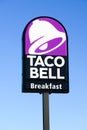 Taco Bell purple sign advertising breakfast on roadside signpost