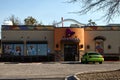Taco Bell side view with a green car