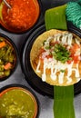 Taco condesa with fried fish on black plate with mexican sauces Royalty Free Stock Photo