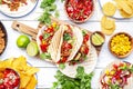 Taco party. Served table with tortillas, nachos, sauces, appetizers and plates. Homemade mexican food cooking scene. White table