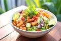 taco salad with spicy shrimp, diced avocado, and lime wedge