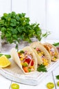 Taco - wheat tortilla with meat, vegetables, corn, greens. Delicious mexican snack Royalty Free Stock Photo