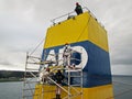 Tacoma, WA, USA, October, 23-25, 2019. Repainting the shipÃ¢â¬â¢s funnel and drawing the logo of the shipowner with m Royalty Free Stock Photo