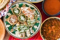 Tacos dorados with chicken and sopes with red and green sauce, frijoles charros, spicy red sauce, traditional mexican food