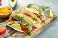 Tacos with grilled chicken, avocado, fresh tomatoes, limes. mexican burritos on a wooden board. banner, menu, recipe place for Royalty Free Stock Photo