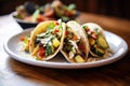 tacos with grilled veggies and feta cheese, focus on cheese crumbles Royalty Free Stock Photo