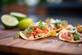 tacos with refried beans, cheese, and pico de gallo garnish