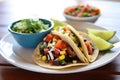 tacos with a side of spicy black bean and corn salsa