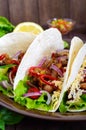 Tacos is a traditional Mexican dish. Tortilla stuffed with chicken, bell and hot peppers, beans, lettuce, cheese