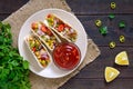 Tacos - wheat tortilla with meat, vegetables, greens and corn with tomato sauce Royalty Free Stock Photo