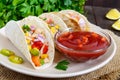 Tacos - wheat tortilla with meat, vegetables, greens and corn with tomato sauce Royalty Free Stock Photo