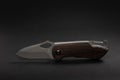 tactical folding knife. EDC knife. on dark background Royalty Free Stock Photo