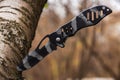 Tactical knife stuck in a tree stump in a forest Royalty Free Stock Photo