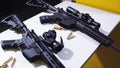 Tactical rifle with a colimator sight and some ammunition on the table Royalty Free Stock Photo