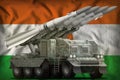 Tactical short range ballistic missile with arctic camouflage on the Niger national flag background. 3d Illustration