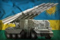 Tactical short range ballistic missile with arctic camouflage on the Rwanda national flag background. 3d Illustration
